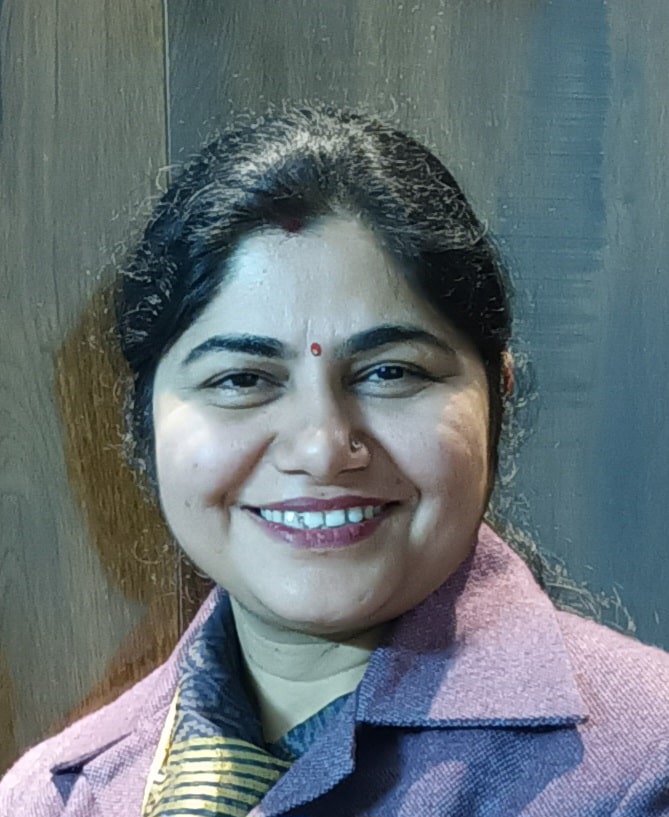 Portrait of Prof. Choudhary wearing white lab coat in chemistry lab
